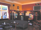 WOOD PANELLED LOUNGE LEADING TO GARDEN